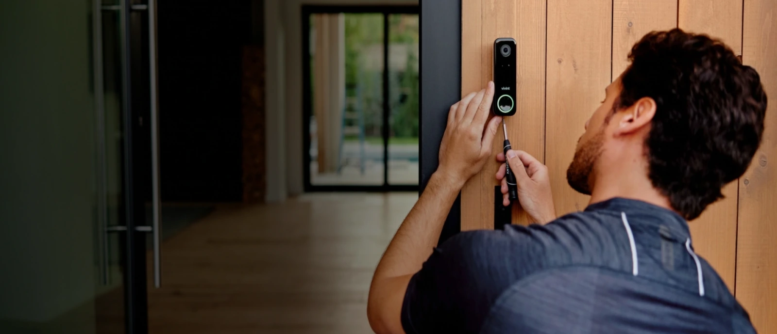 Certified professional technician installing and calibrating a residential smart security system